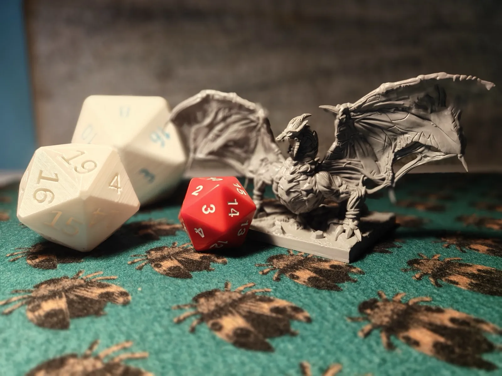 Detailed dragon figurine posed with dice