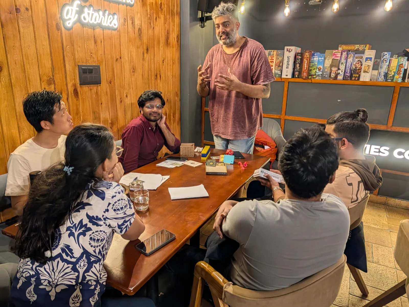 Workshop facilitator leading a serious game session with participants seated around a table