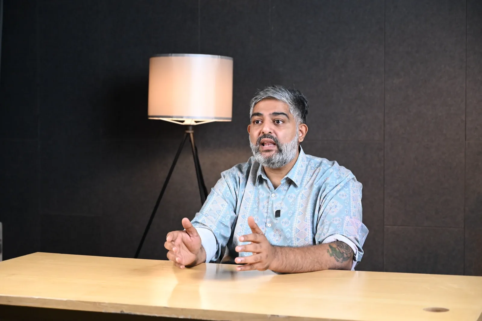 Workshop facilitator gesturing while speaking to camera
