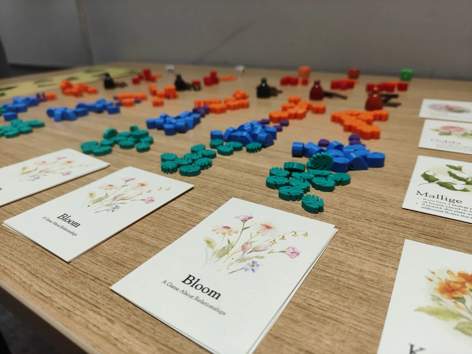 Bloom garden game cards and colourful flower pieces laid out on a table