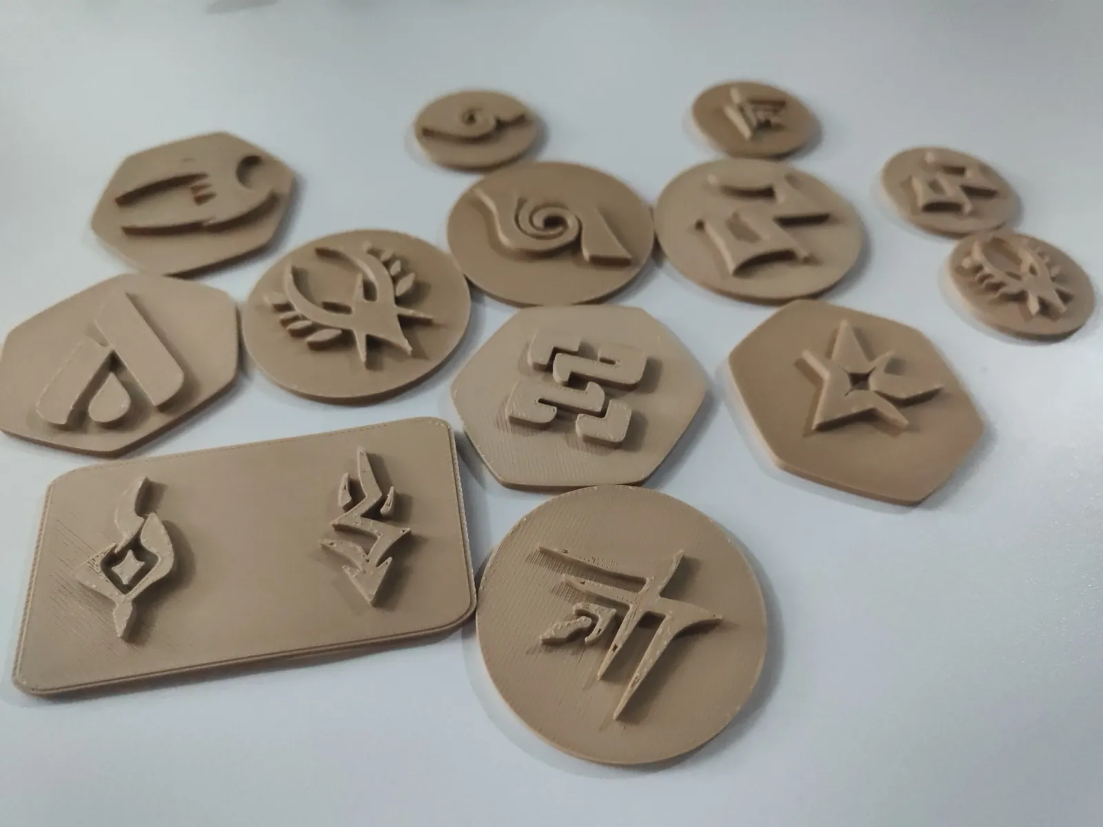 Handcrafted clay game tokens stamped with symbols
