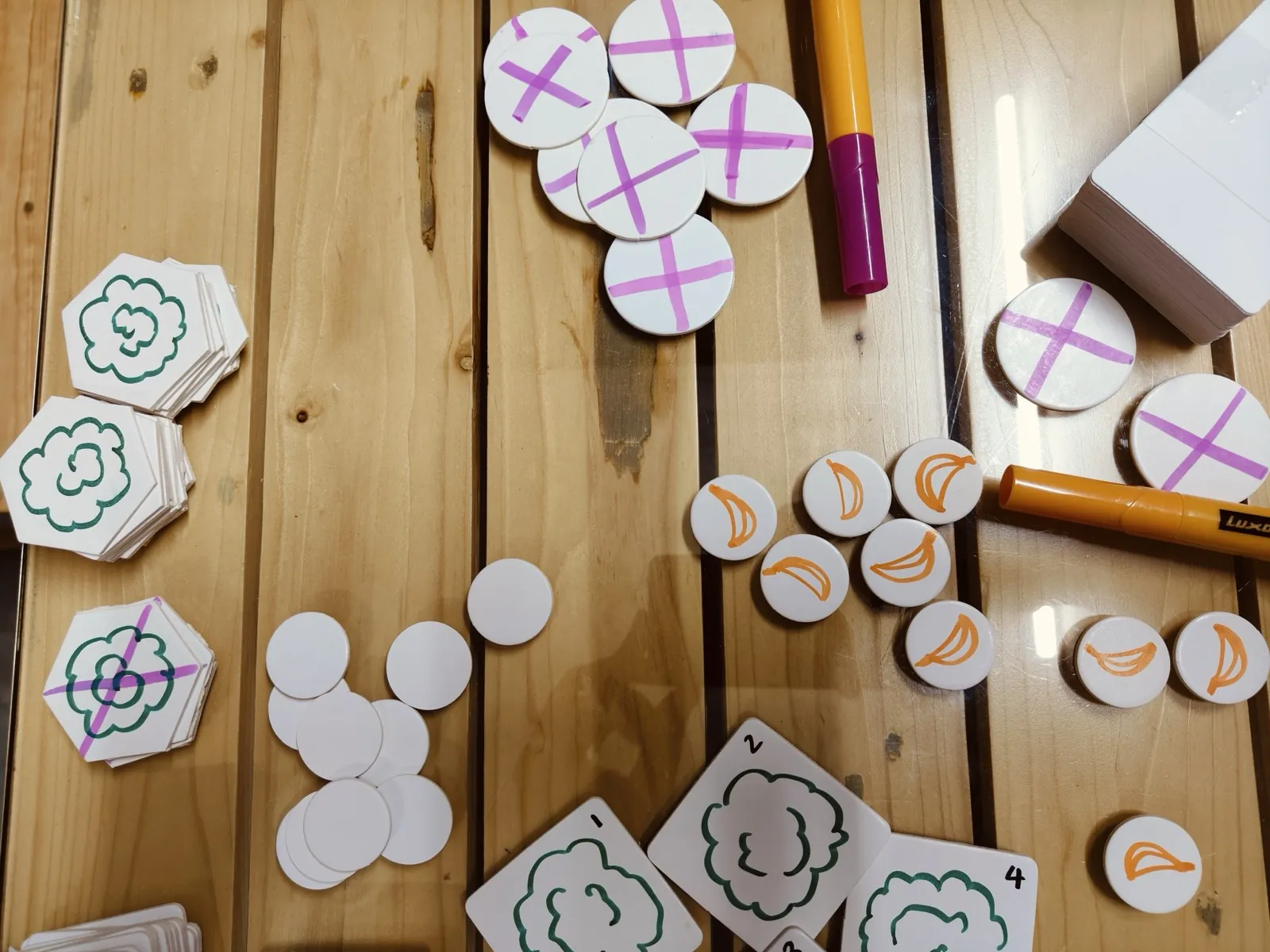 Hexagonal wooden tokens and markers on a table