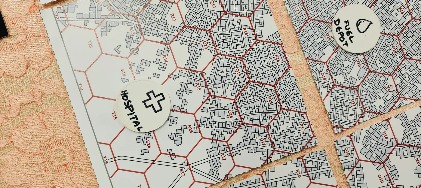 Hospital and fuel depot location tokens placed on the Zombiepuram hex map of the city