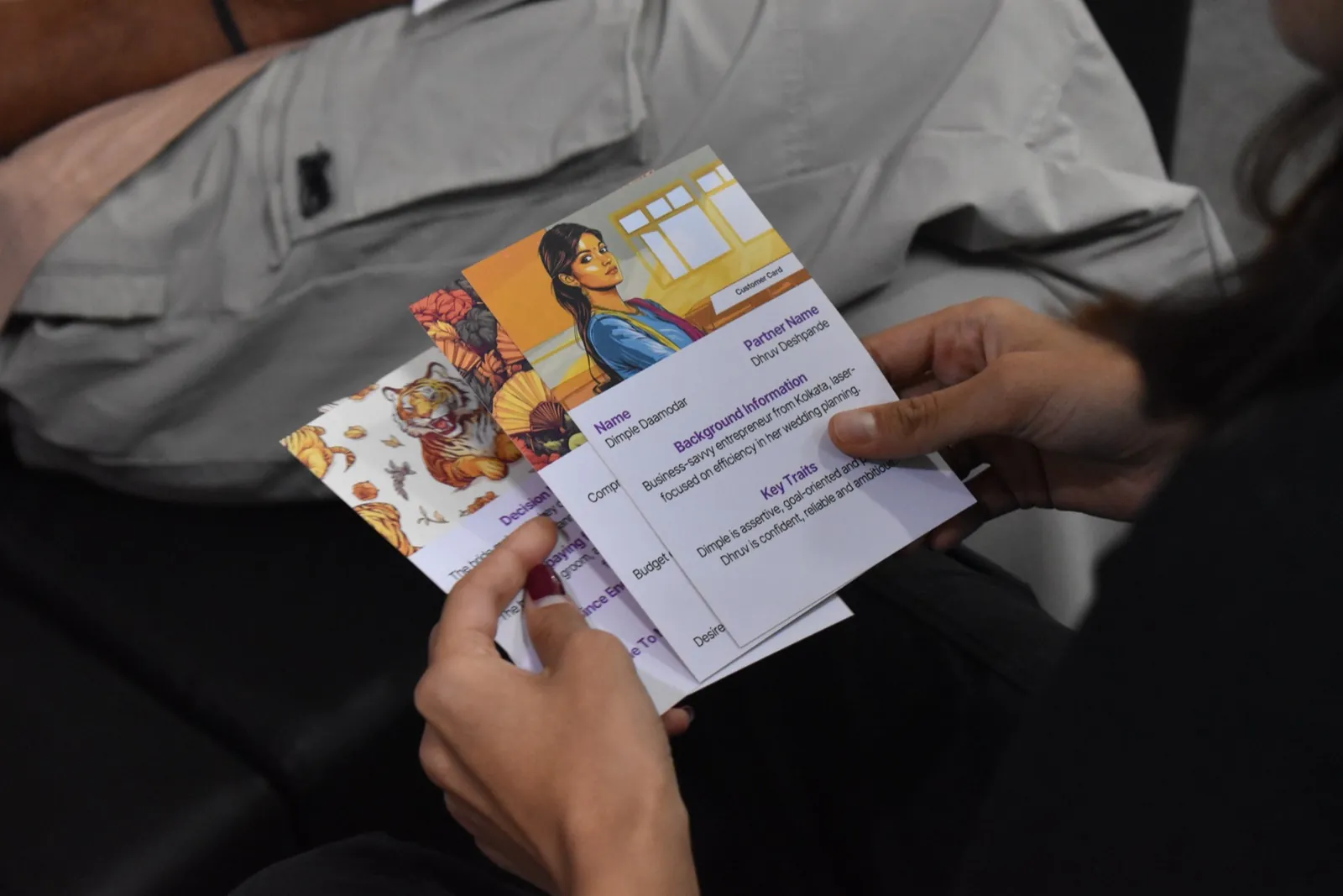 Participant holding an illustrated game card booklet