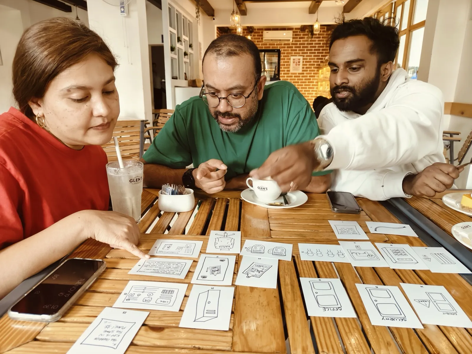 Participants discussing strategy over game cards and notes