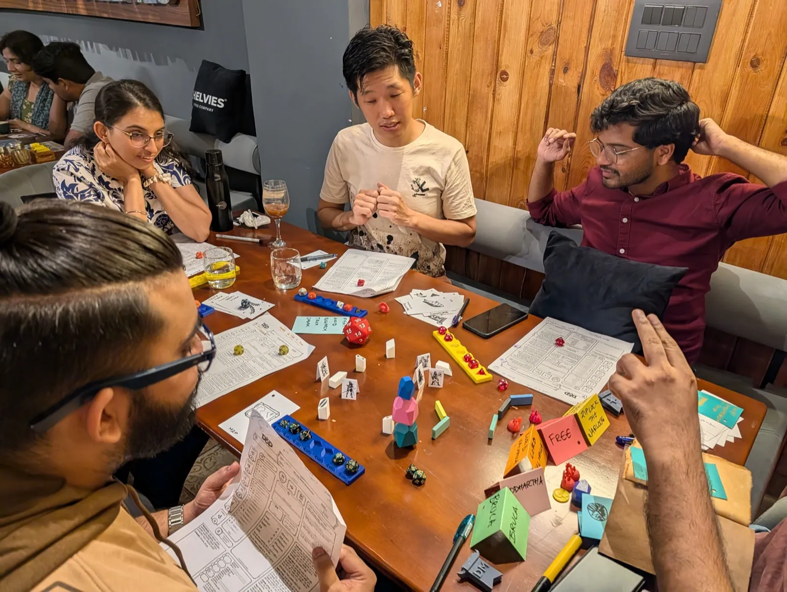 Players focused on a tabletop game at a group workshop