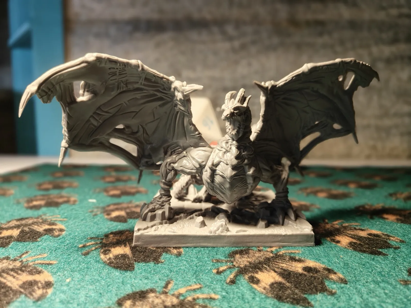 Detailed tabletop dragon miniature on a gaming mat