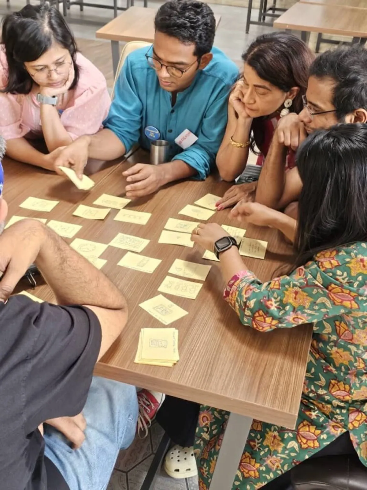 Team playing a card game together in a relaxed group setting
